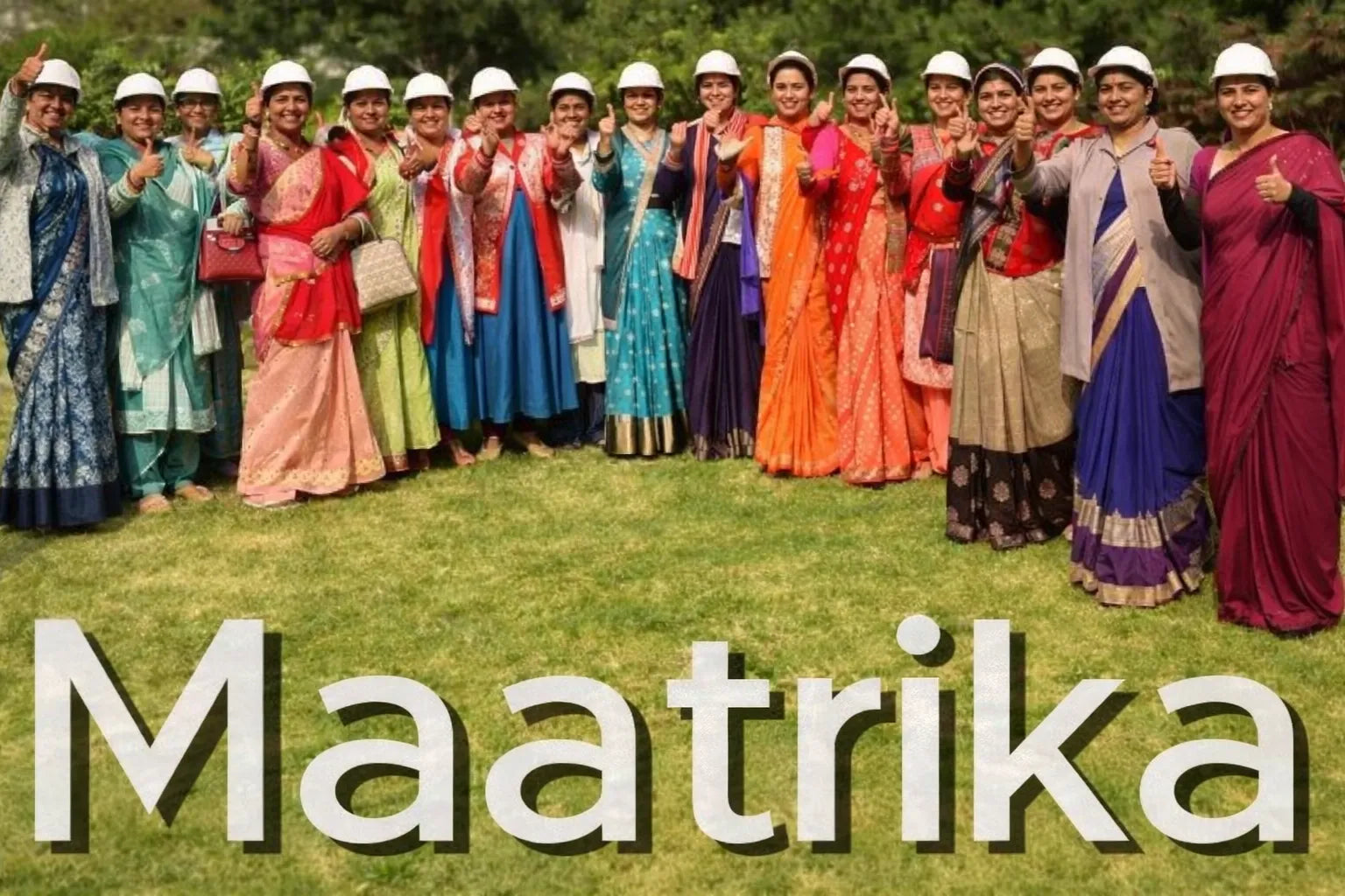 Group of women in colorful traditional attire with 'Maatrika' text overlay on a grassy background